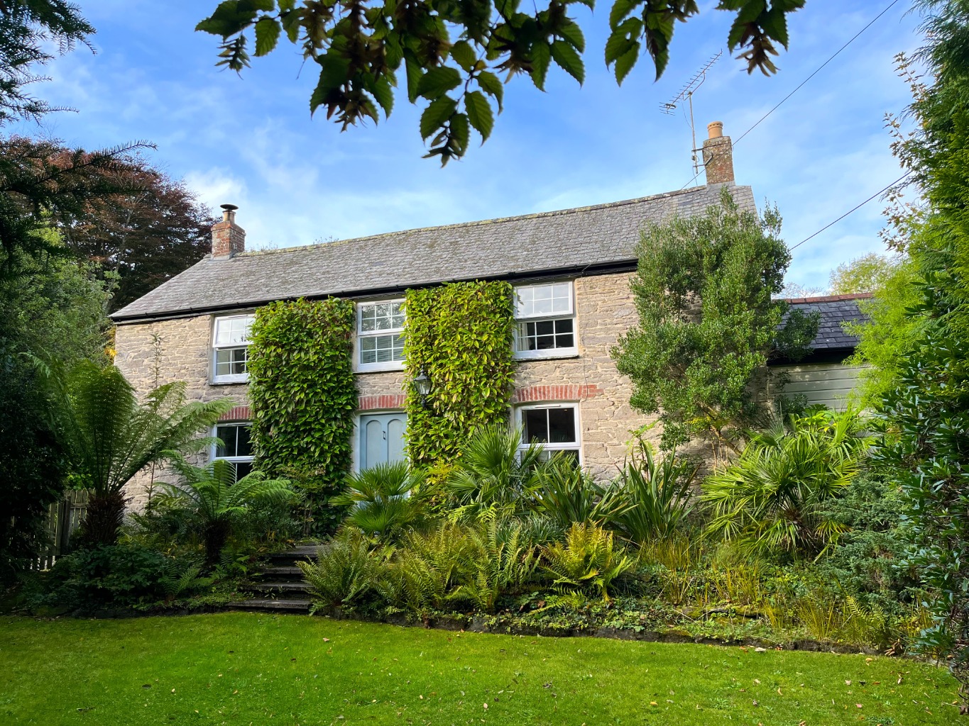 Quintessential detached cottage in Veryan with private subtropical garden, garage and parking.