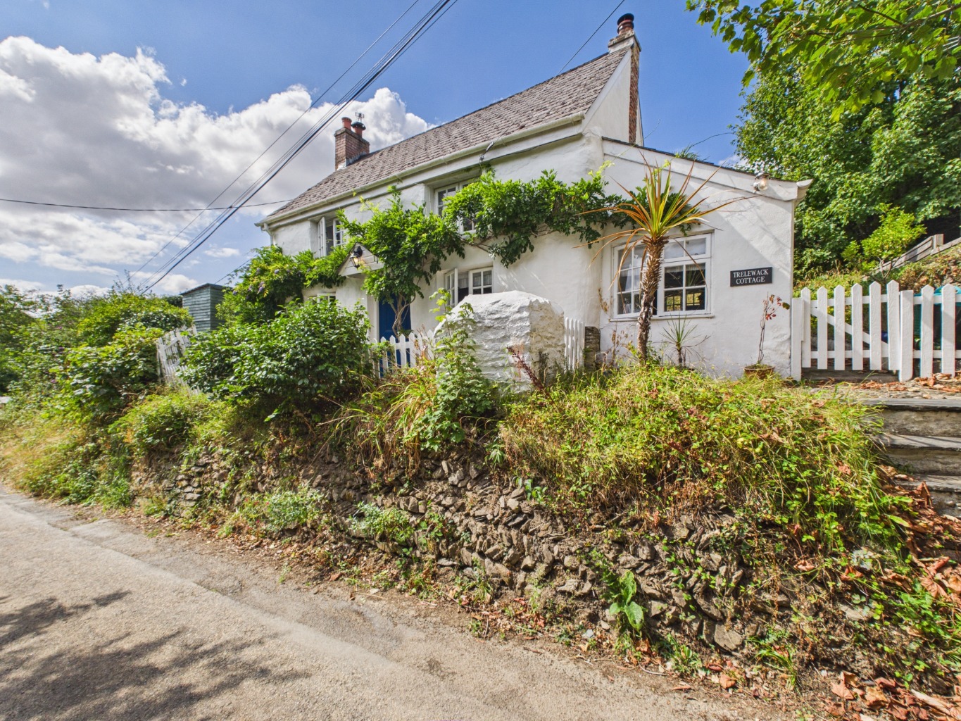 Charming Grade II Listed cottage with delightful country views, generous gardens and orchard.