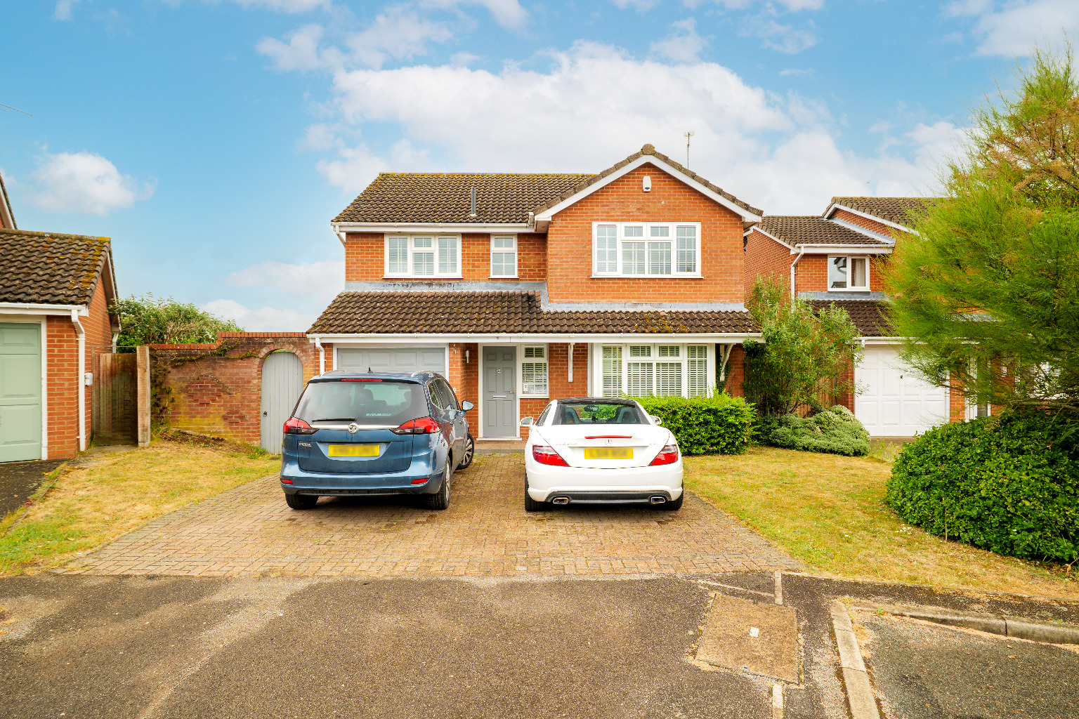 A Four Bedroom Detached House with a Garage and Driveway