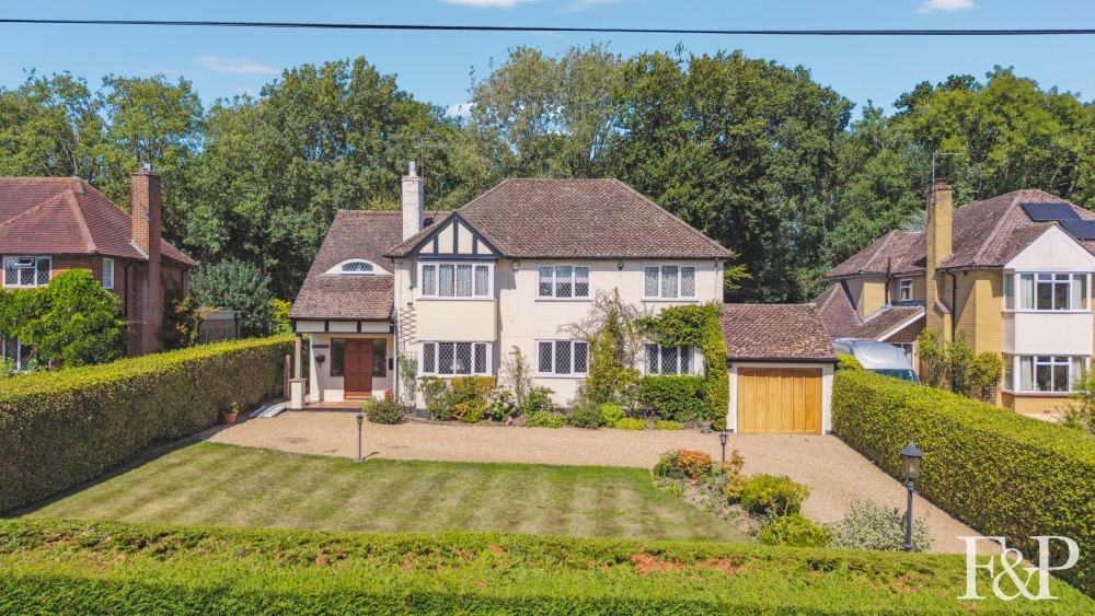 A handsome 1930s family home with picture postcard gardens to the front and rear.