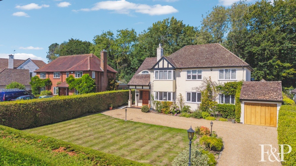 A handsome 1930s family home with picture postcard gardens to the front and rear.