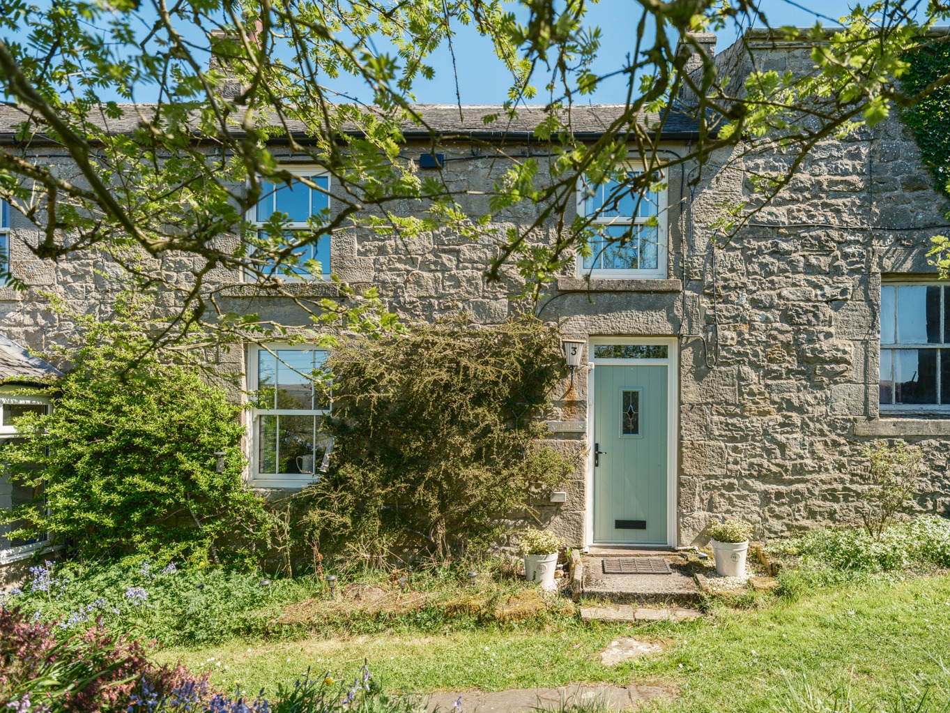 This recently refurbished cottage at East Woodburn is for sale with no onward chain!